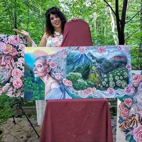 Andrea Castaneda with her paintings